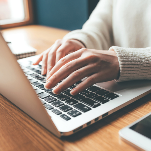 image offhand working on a laptop